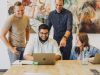 Darren and Mike MLM Success and How the Dream Team Model Differs from a Pyramid Scheme Team of online business mentors reviewing digital marketing strategy together on a laptop