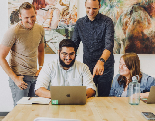 Darren and Mike MLM Success and How the Dream Team Model Differs from a Pyramid Scheme Team of online business mentors reviewing digital marketing strategy together on a laptop